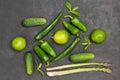 Green peppers, asparagus, cucumbers and limes on table