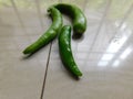 The green peppers are isolated on a white surface
