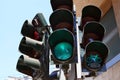 A green permissive light for pedestrians and bicycles shines at the traffic light