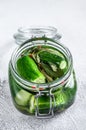 Green pickle cucumbers in a glass jar. Natural product. White background. Top view