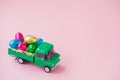 Green pickup toy carrying Easter Egg chocolates