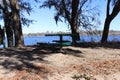 Green picnic table in park near the water Royalty Free Stock Photo