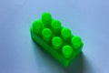 green piece of block. Top angle view of lego brick on white background Royalty Free Stock Photo