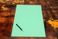 A green piece of paper with a pencil on it Royalty Free Stock Photo