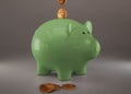 Green piggy bank with cryptocurrencies, golden physical coins, Ripple, Zcoin, Bitcoin and Etherium. Mining cryptocurrency