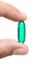 Green pill in hand Royalty Free Stock Photo