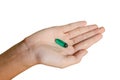Green pill on hand