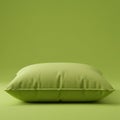 A green pillow is centrally placed against a matching green backdrop, creating a Royalty Free Stock Photo