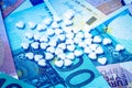 Green pills on the background of euro bills. The concept of the expensive cost of healthcare Royalty Free Stock Photo