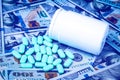 Green pills on the background of one hundred dollar bills. The concept of the expensive cost of healthcare or financing medicine. Royalty Free Stock Photo