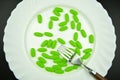 Green pills with fork