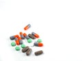 Green pills and orange capsules isolated white, Medicines, Tablets, Drug, Healthcare medical Royalty Free Stock Photo