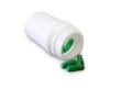 Green pills and pill bottle Royalty Free Stock Photo