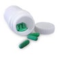 Green pills and pill bottle Royalty Free Stock Photo