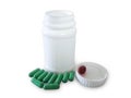 Green pills and pill bottle Royalty Free Stock Photo