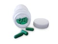 Green pills and pill bottle Royalty Free Stock Photo