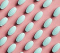 Green pills on pink background Royalty Free Stock Photo