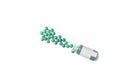 Green pills spilling out of bottle isolated on white background. Top view, copy space Royalty Free Stock Photo