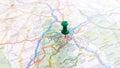 A green pin stuck in Clermont Ferrand on a map of France
