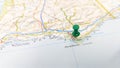 A green pin stuck in Faro Algarve on a map of Portugal