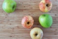 Green and pink apples on wooden background