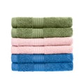 Green, pink and blue bath towels in stack isolated over white background with clipping path Royalty Free Stock Photo