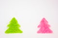 Green and pink Christmas trees on a white background with copy space Royalty Free Stock Photo