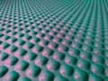 Green and pink rubber mat texture closeup inside a gym. Perspective view of fitness floor background with copy space