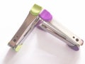 Green and pink stapler mags on white background. Royalty Free Stock Photo