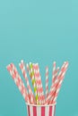 Green And Pink Striped Straws In A Party Paper Cups