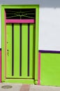 Green pink wooden door of a colonial house front Royalty Free Stock Photo