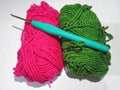 Green and pink Wool yarn and knitting needle on white background. Royalty Free Stock Photo