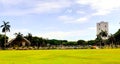 Green plains of the historic Luneta park capturing the famous photo bomber building