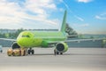The green plane pushes the tow tractor before starting the engines and taxiing, front view Royalty Free Stock Photo