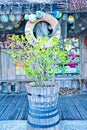 A green plant sits in a rustic oak barrel outside a fishing themed establishment in Key West, Florida, USA