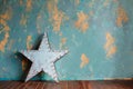 Green plaster wall and vintage metal star with lamps. Royalty Free Stock Photo