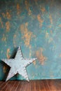 Green plaster wall and vintage metal star with lamps. Royalty Free Stock Photo