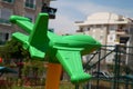 Green plastic airplane on the playground Royalty Free Stock Photo