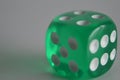Green plastic arcylic d6 six sided die dice close up variable focus Royalty Free Stock Photo