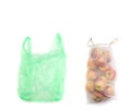 Green plastic bag and reusable recycled mesh net grocery bag full of fresh apples, comparison on white background, concept of zero Royalty Free Stock Photo