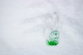 Green plastic bottle lying in the snow Royalty Free Stock Photo