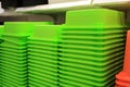 Green plastic boxes lie on the shelf of the store
