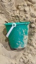 green plastic bucket lies in the sand, children& x27;s toy, object, beach Royalty Free Stock Photo