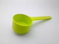 Green plastic coffee spoon on white background Royalty Free Stock Photo