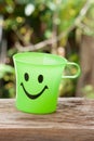 Green plastic cup with a smile. Royalty Free Stock Photo