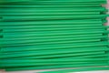 Green plastic drinking straw