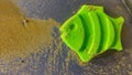 green plastic fish toy in the sand, children& x27;s toy, object, beach Royalty Free Stock Photo