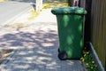 Green plastic garbage can or trash disposal bin on wheels Royalty Free Stock Photo