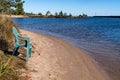 Green plastic lawn chair on the beach, near Bete Grise bay on Lake Superior Michigan