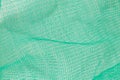 Green plastic mesh close-up, texture of packaging mesh for vegetables Royalty Free Stock Photo